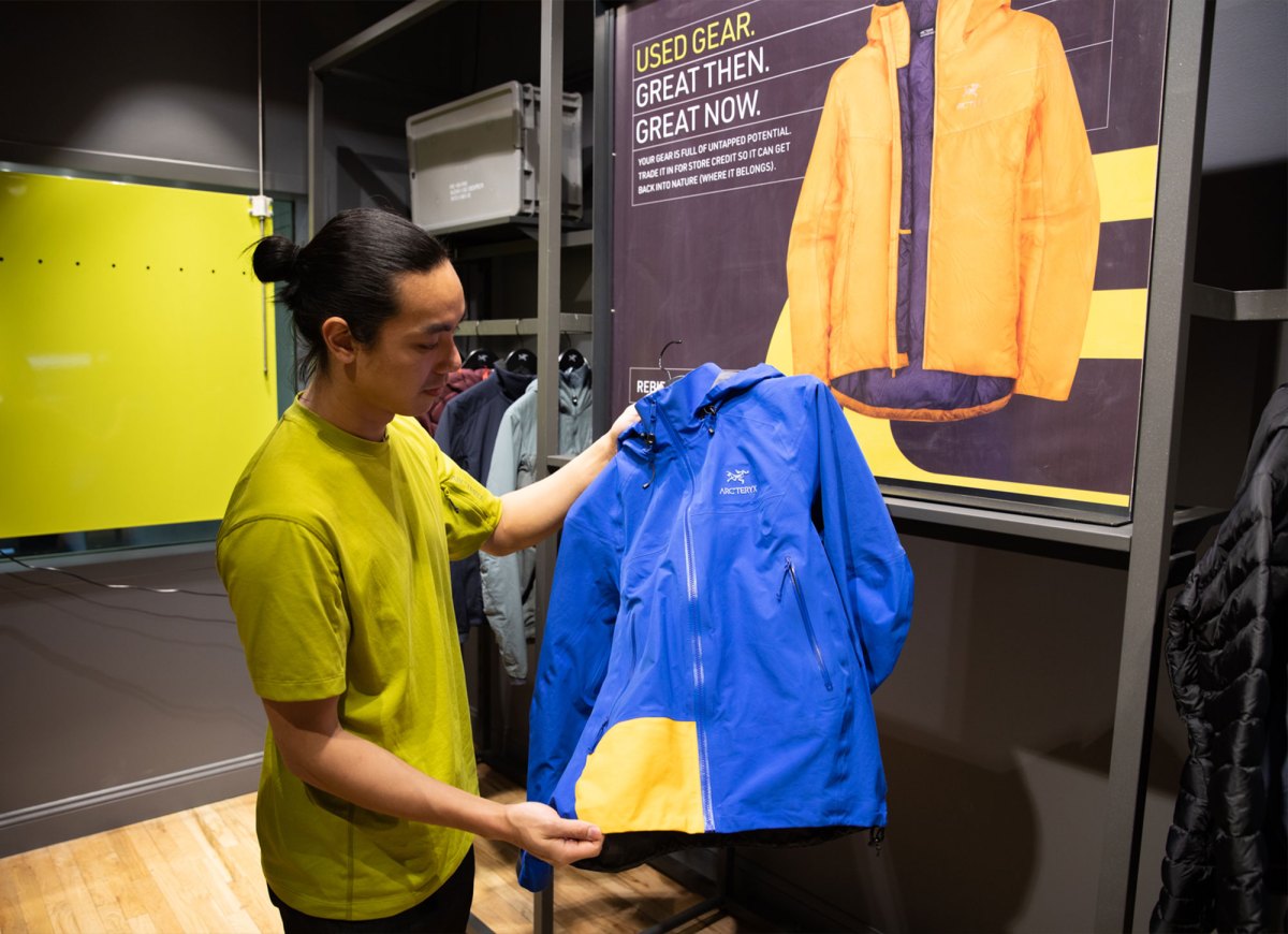 Sales associate Johnson Nguyen holds a refurbished coat at Arc’teryx’s ReBird Service Center in New York City last February. 