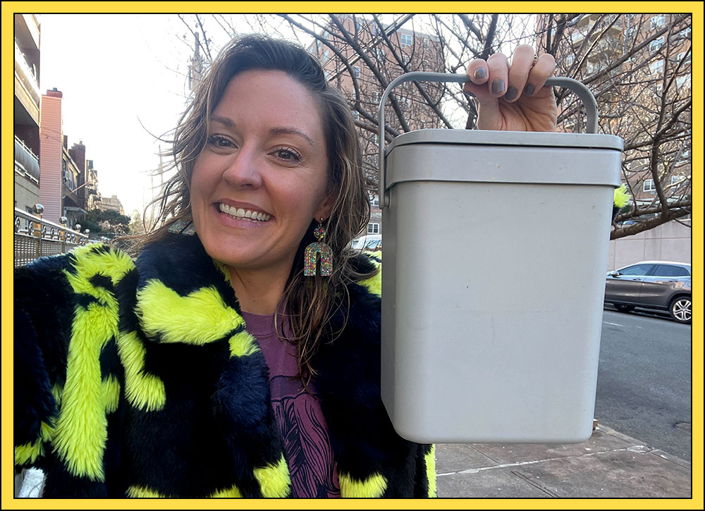 Rachel poses with her compost bin on the streets of Queens (wearing a Rent the Runway coat).