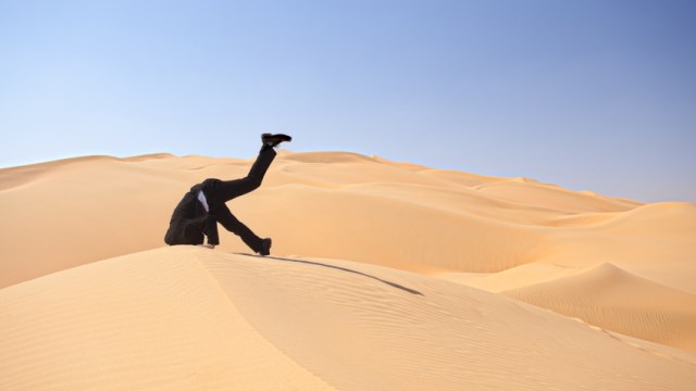 man with head in sand