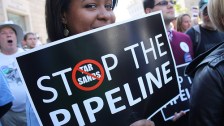 Protestor with "Stop the Pipeline" sign