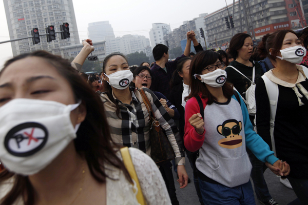 People shout slogans as they march during a protest against plans to expand a petrochemical plant in Ningbo, Zhejiang province October 28, 2012.