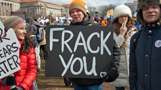 guy holding "frack you" sign