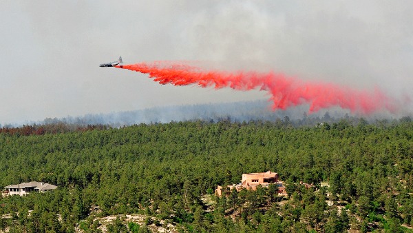 An aircraft releases fire-retardant over Black Forest, Colo.