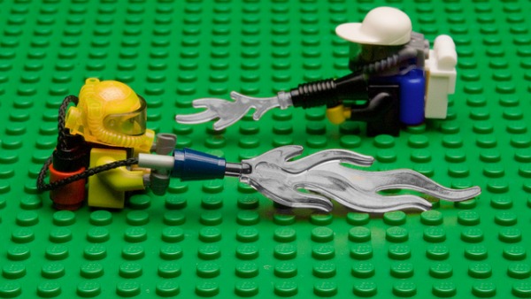 Lego men spraying lego herbicide on a lego field.