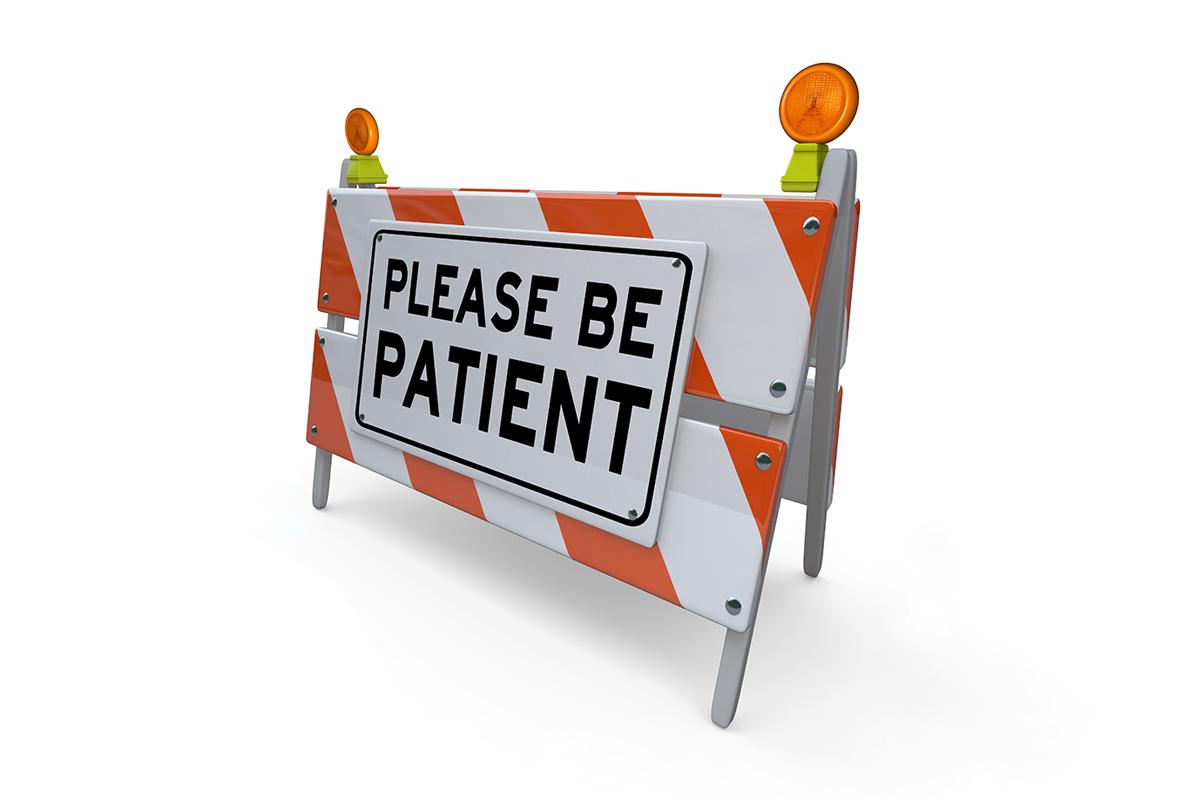 "please be patient" sign