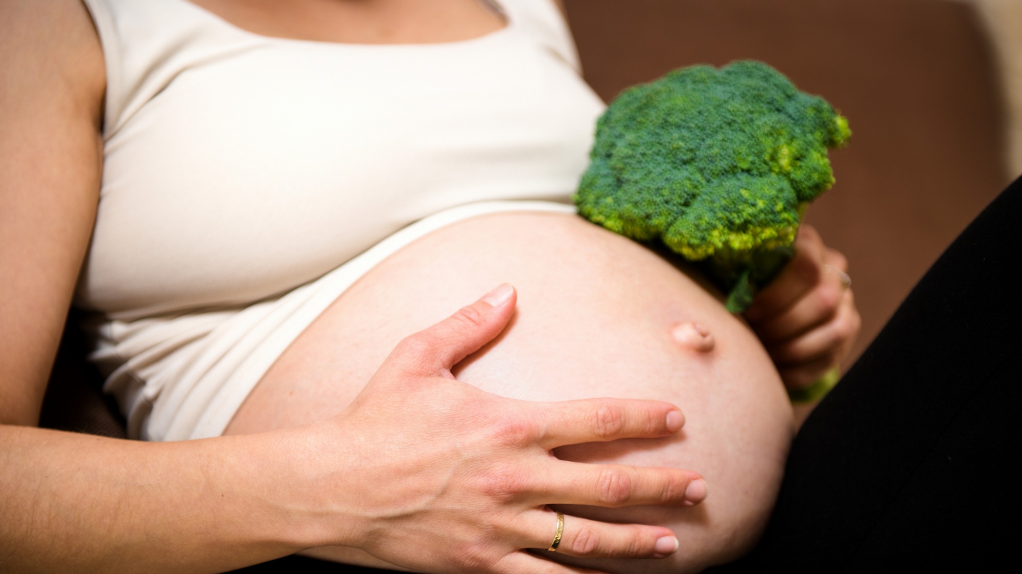 A pregnant lady with broccoli