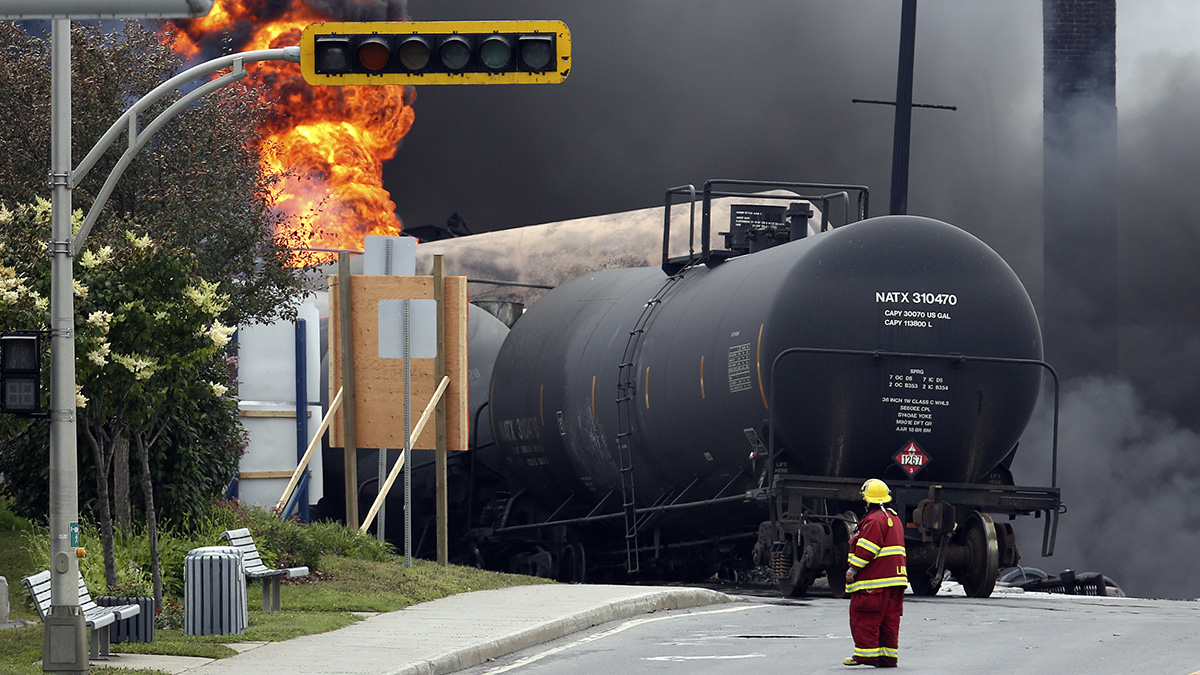 A firefighter walks past a burning train wagon at Lac Megantic, Quebec, July 6, 2013.