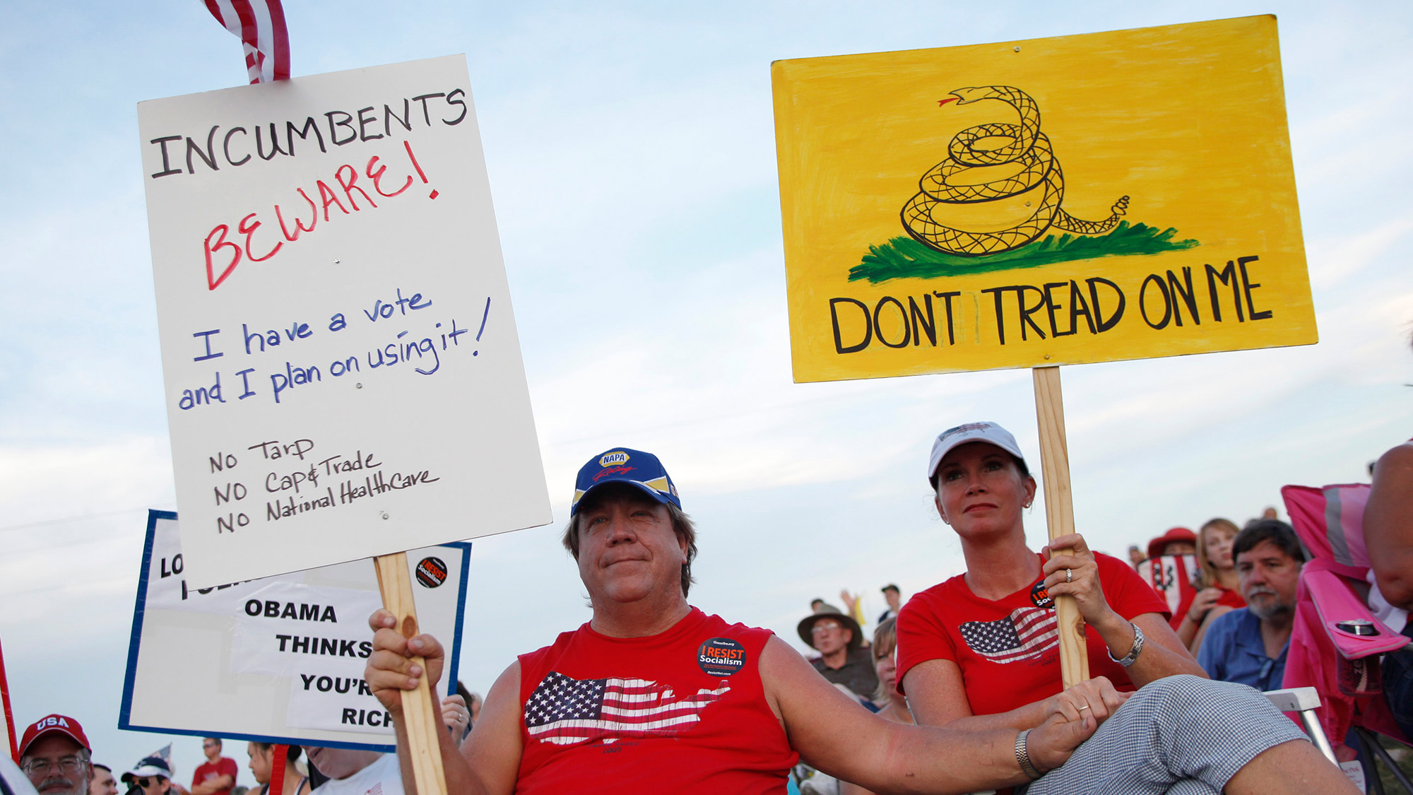 A couple holds protest signs at America's Tea Party held at Southfork Ranch in Parker, Texas.