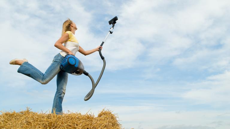 woman vacuuming sky