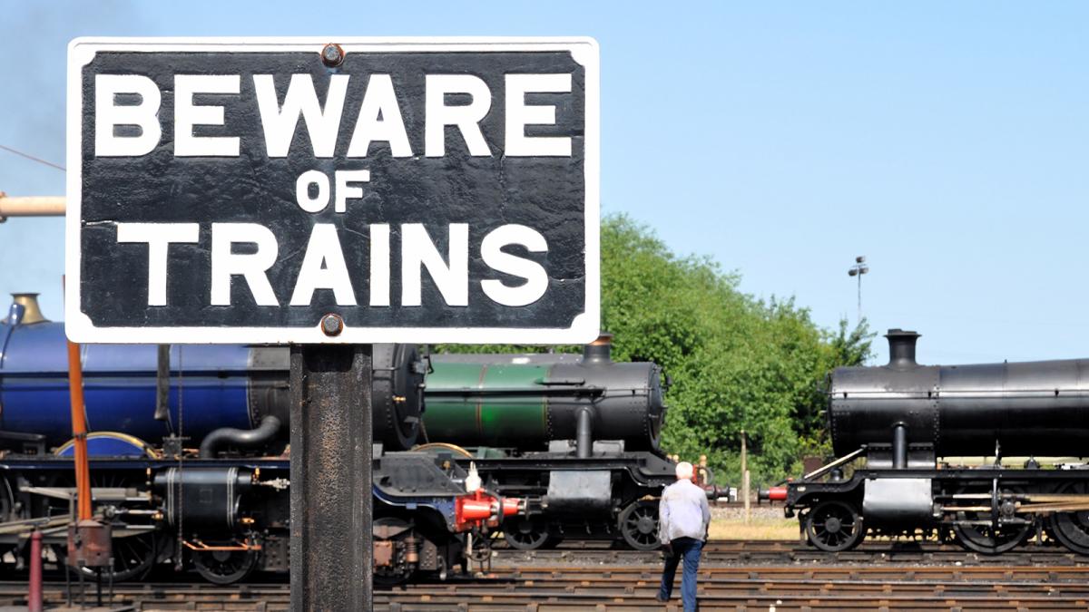 "beware of trains" sign