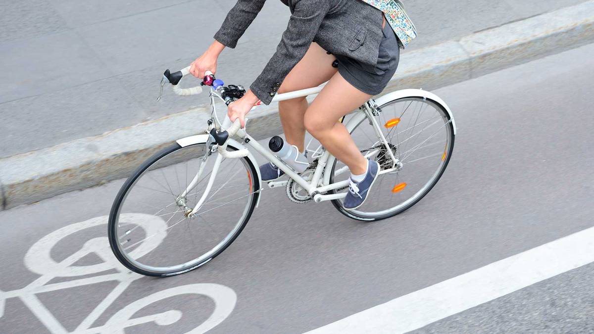 Woman riding bike in bike lane
