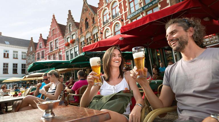 Couple having beer in Bruges, Belgium