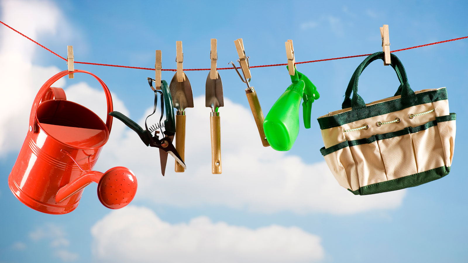 Gardening tools hung up on clothesline