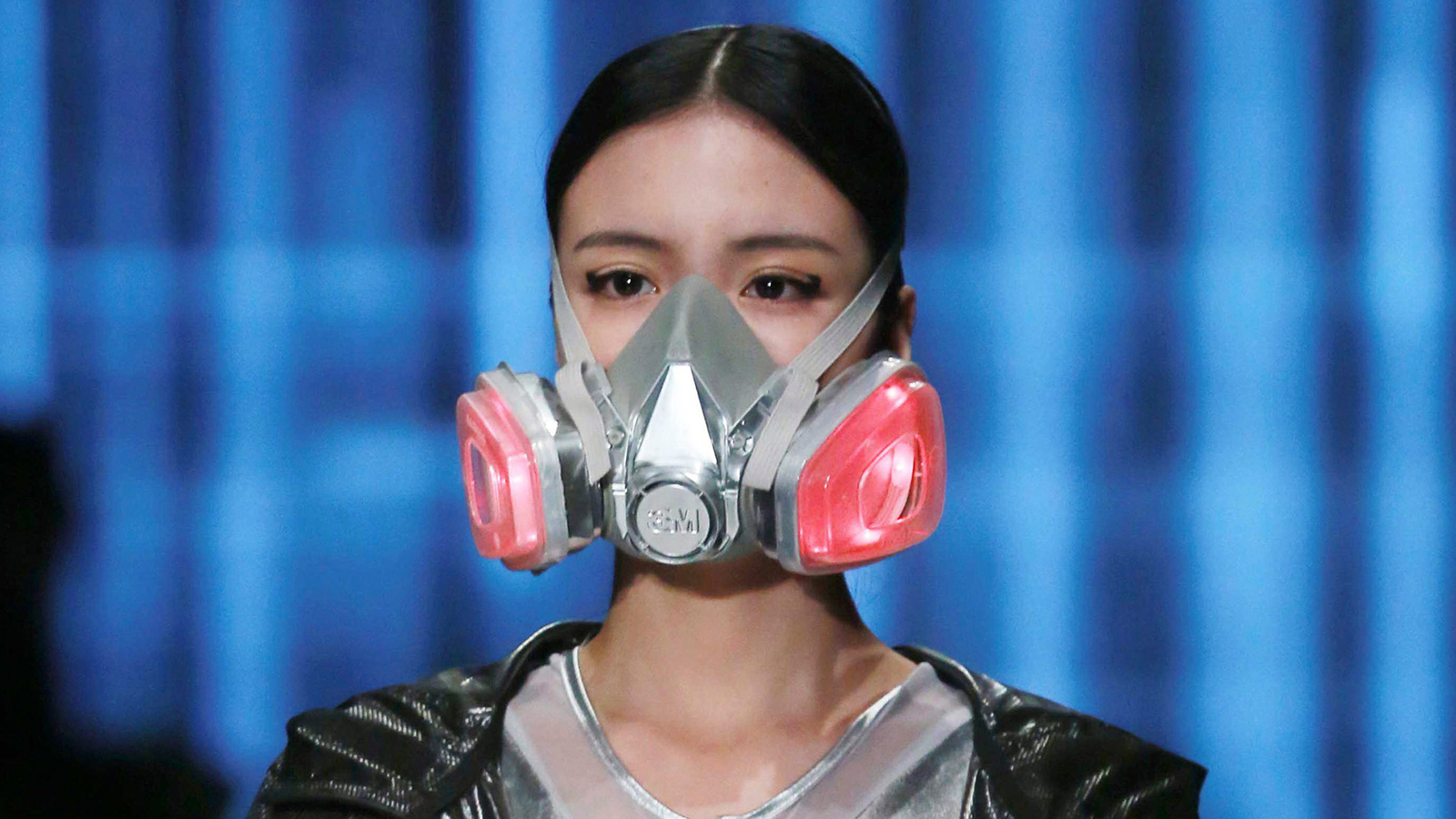 A model wearing a mask presents a creation at the QIAODAN Yin Peng Sports Wear Collection show during China Fashion Week in Beijing, October 28, 2014.