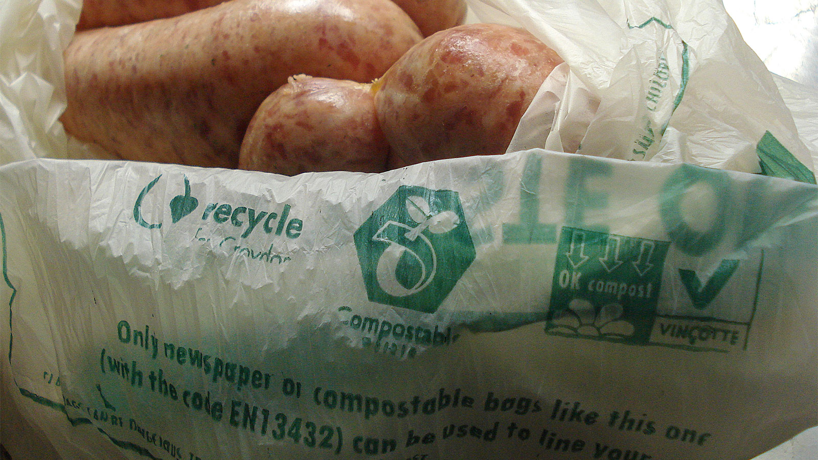 Compostable plastic bag filled with delicious sausages.