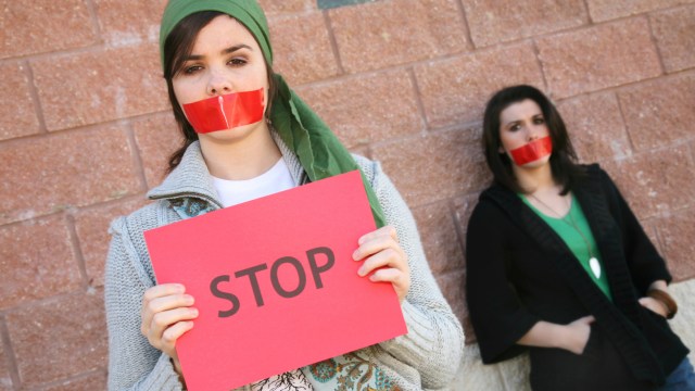 censored activists with "stop" sign