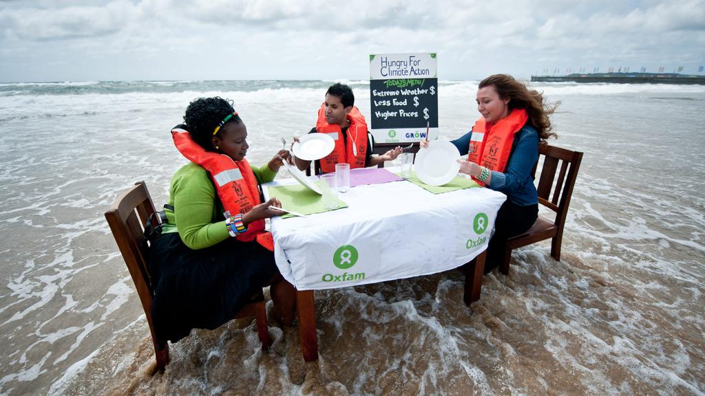 Climate activists at a table in the sea