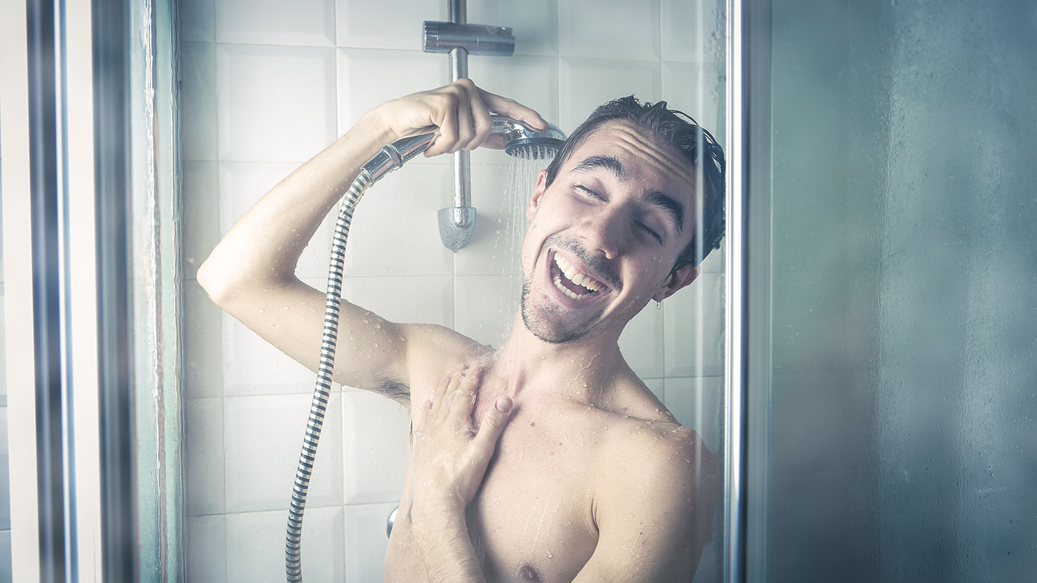 Happy man in steamy shower. 