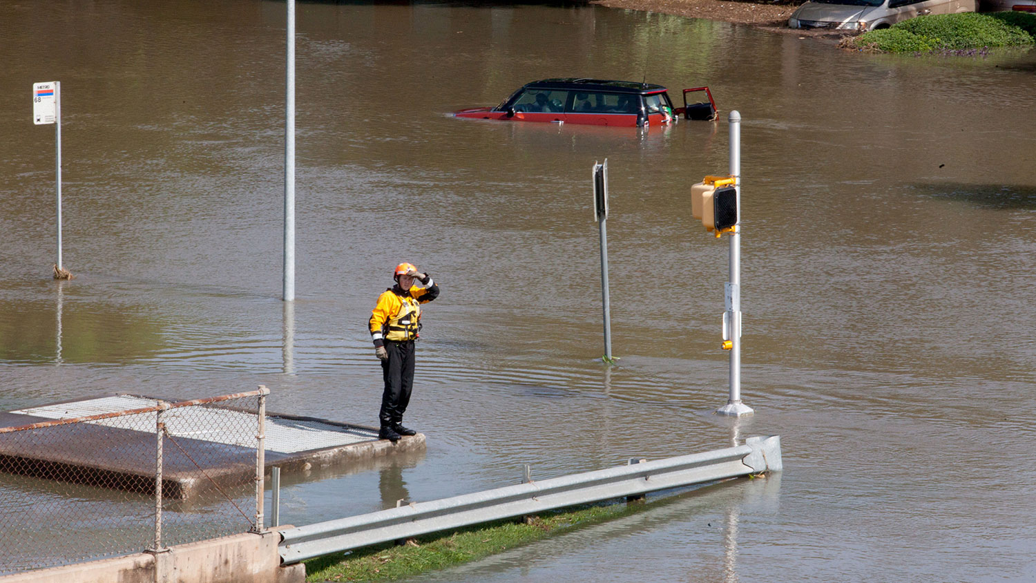 rescue worker on a flooded street