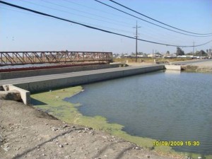 The Russell Avenue bridge once passed more than 2 feet above the water, but it has been sinking as a result of groundwater pumping and now is nearly submerged in the canal.