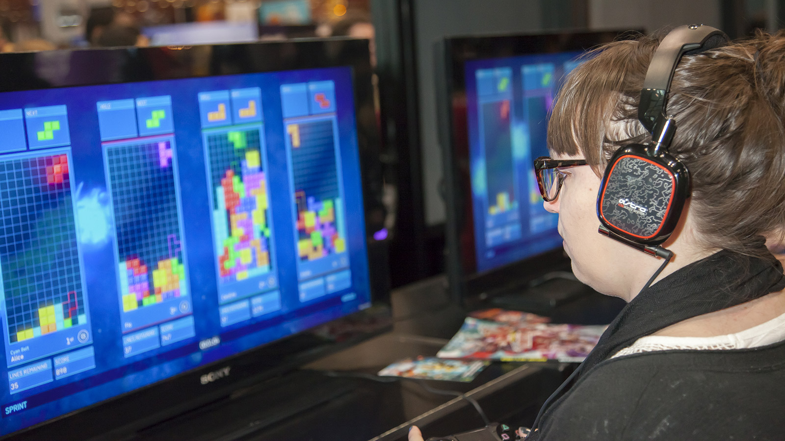 Comic Con attendee plays Tetris Ultimate during Comic Con 2014 at The Jacob K. Javits Convention Center in New York City