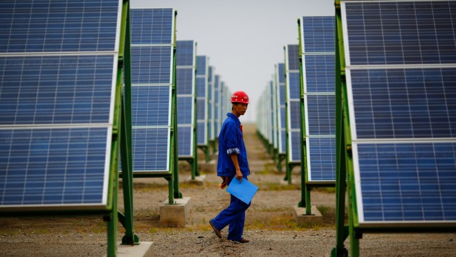 Chinese worker and solar panels
