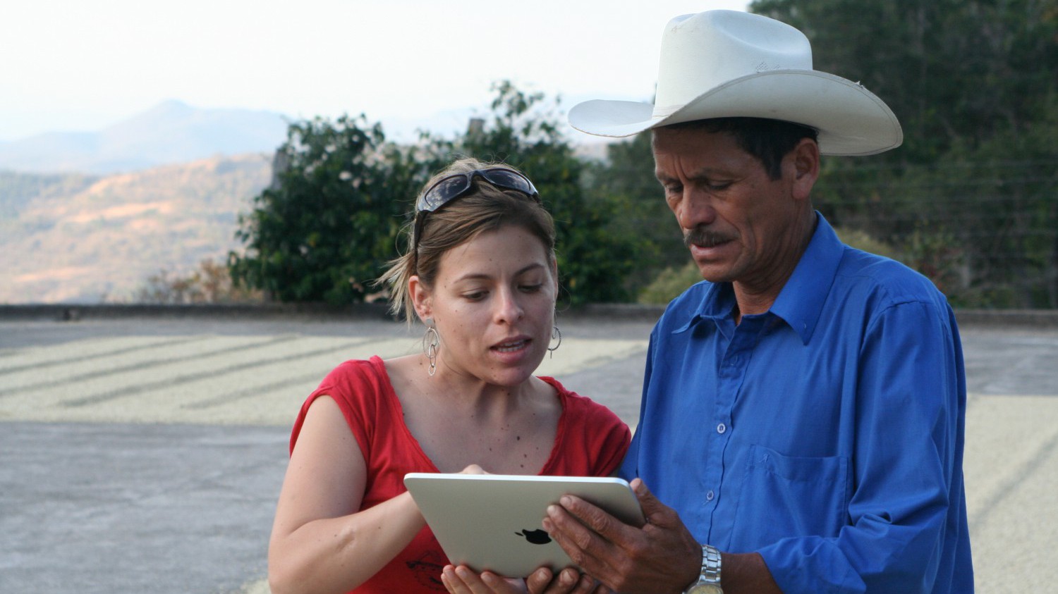 A Sustainable Harvest representative working with a farmer in Colombia