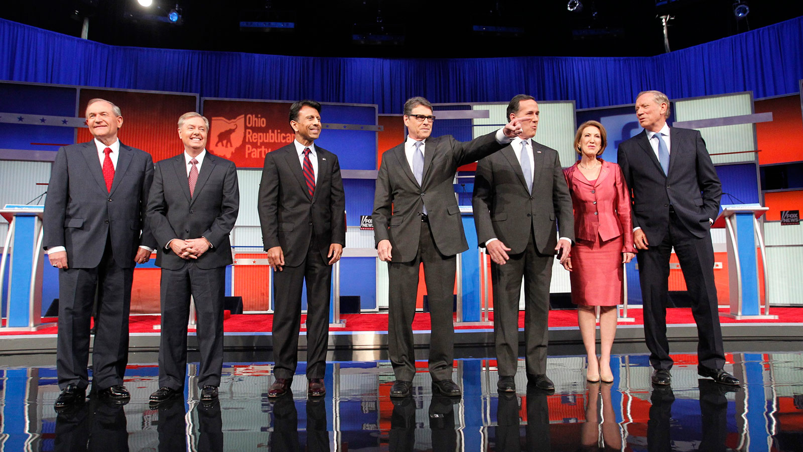 Republican presidential candidates (L-R), former Virginia Governor Jim Gilmore, U.S. Senator Lindsey Graham, Louisiana Governor Bobby Jindal, former Texas Governor Rick Perry, former U.S. Senator Rick Santorum, former HP CEO Carly Fiorina and former New York Governor George Pataki, pose before the start of a Fox-sponsored forum for lower polling candidates held before the first official Republican presidential candidates debate of the 2016 U.S. presidential campaign in Cleveland, Ohio, August 6, 2015.