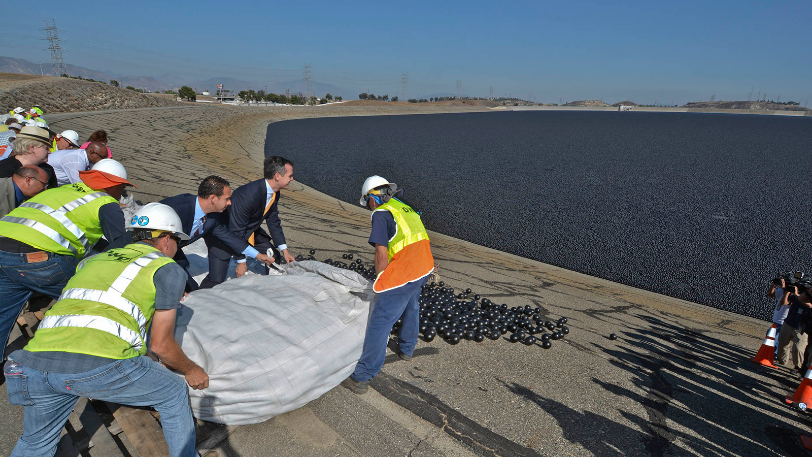 Council member Mitch Englander and LA Mayor Eric Garcetti along with LADWP workers releasing shade balls into the LA Reservoir
