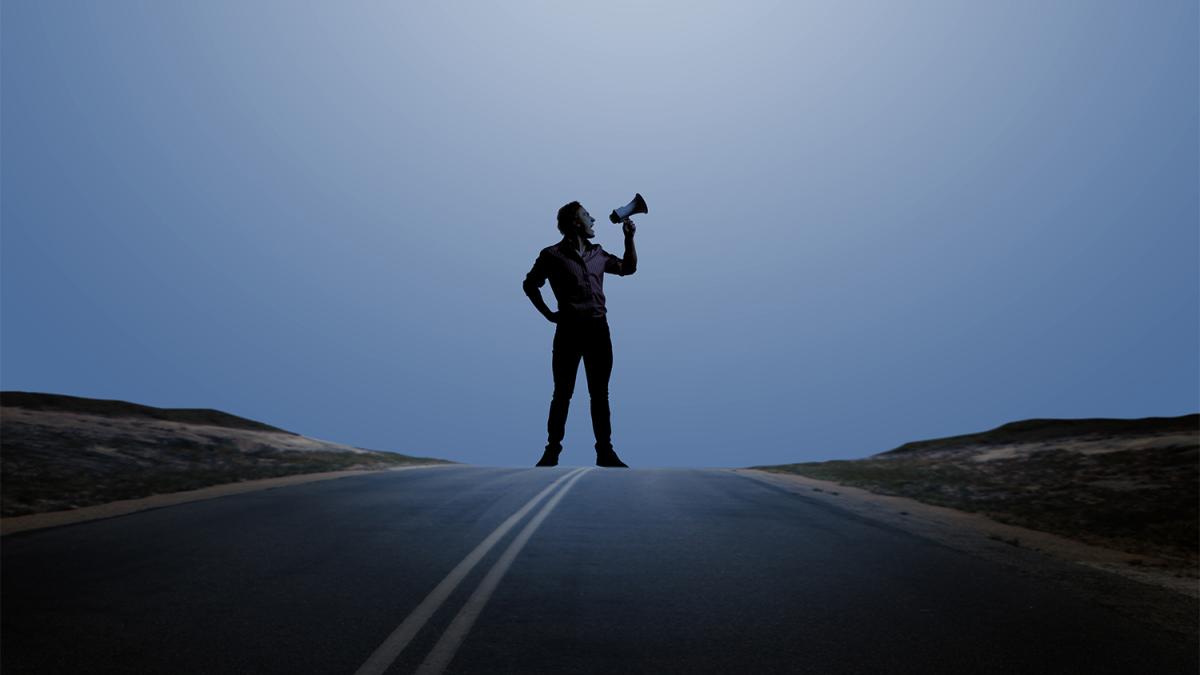 Man standing with megaphone in hand