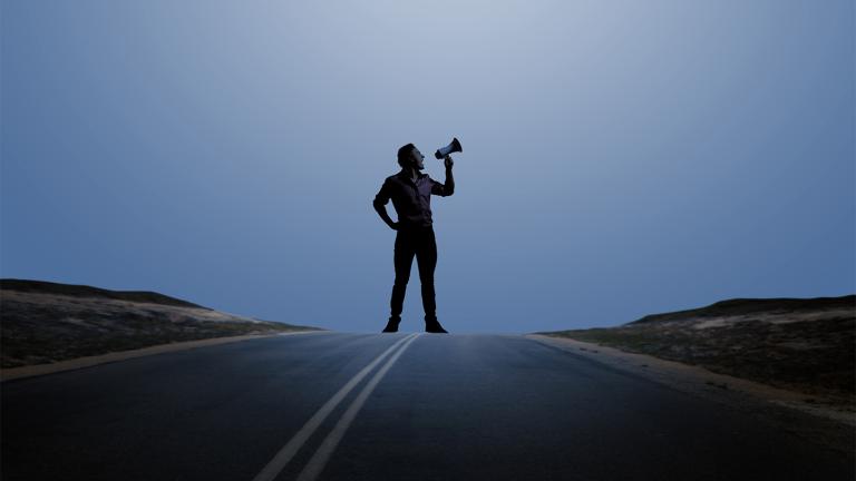 Man standing with megaphone in hand