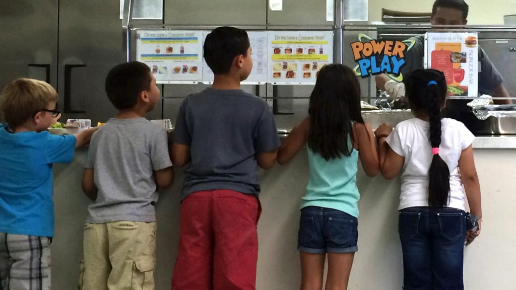 First graders at Washington Elementary School in Riverside, California, line up for hot food after choosing fruits and vegetables from the salad bar on October 13, 2015