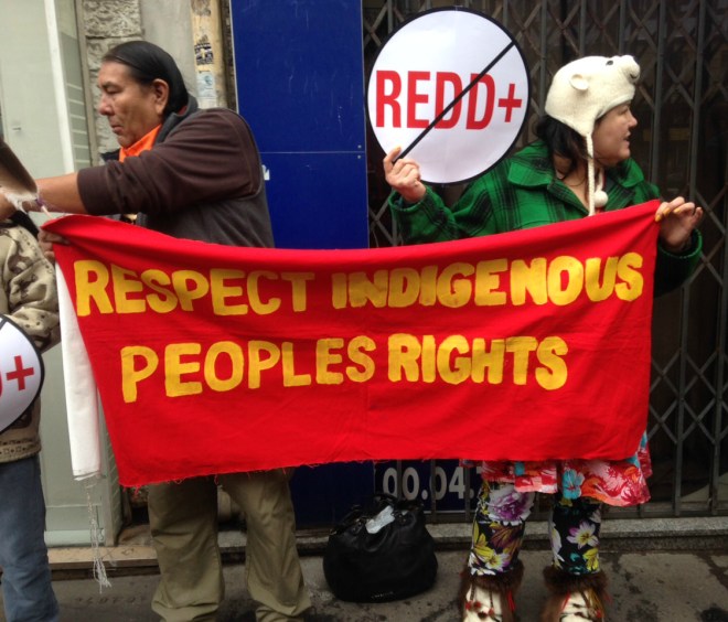 activists with sign: "Respect Indigenous Peoples Rights"