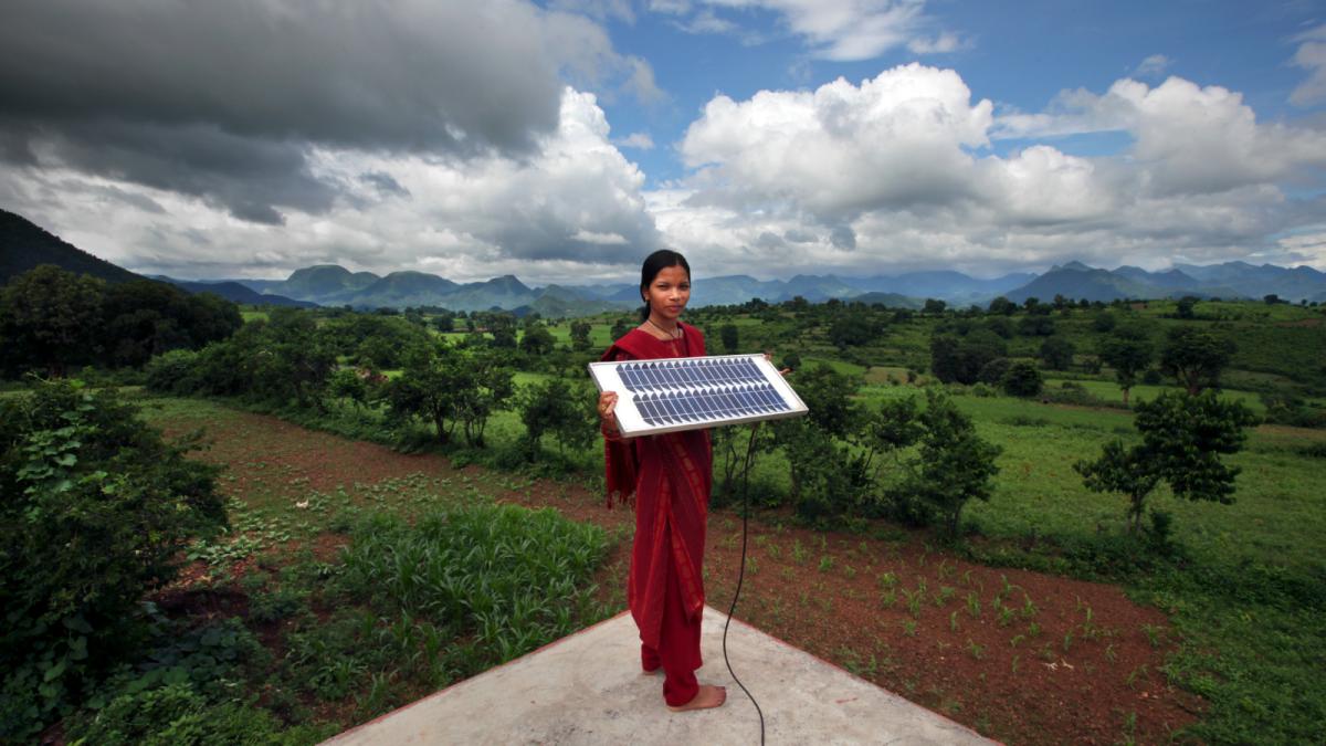 Indian woman on roof with solar module