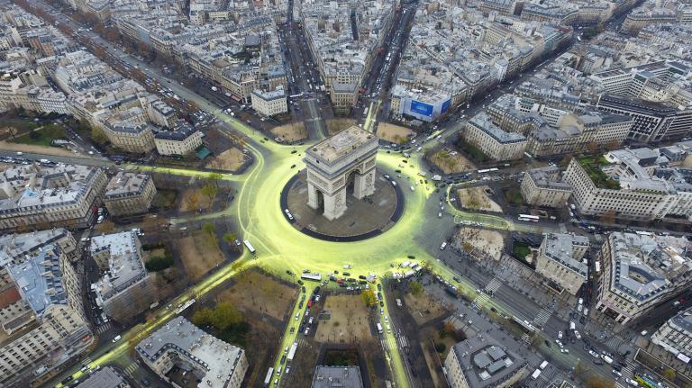 Greenpeace activists create a solar symbol around the world-famous Paris landmark, the Arc de Triomphe.