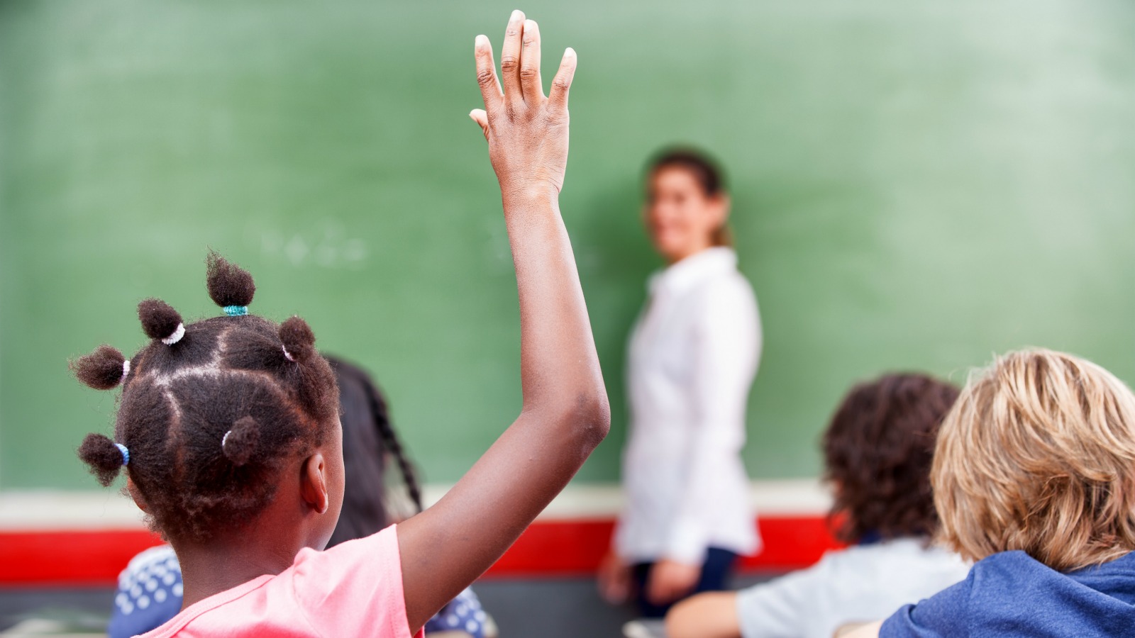 Were at primary school. Primary School children raising hand.