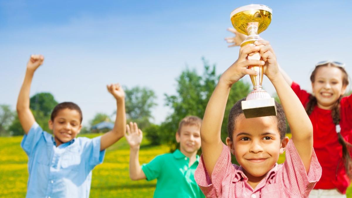 Happy kids with a trophy.