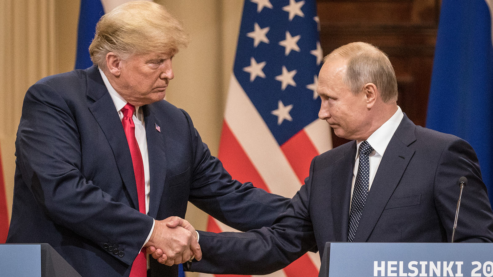 U.S. President Donald Trump (L) and Russian President Vladimir Putin shake hands during a joint press conference after their summit on July 16, 2018 in Helsinki, Finland.