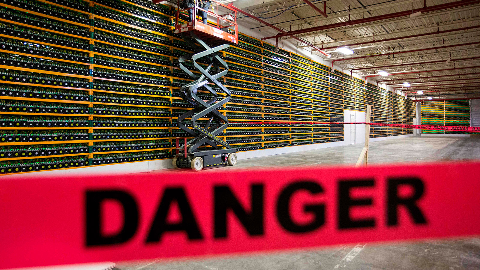 Two construction workers use a lift along a wall of bitcoin mining at Bitfarms in Saint Hyacinthe, Quebec on March 19, 2018. Bitcoin is a cryptocurrency and worldwide payment system.