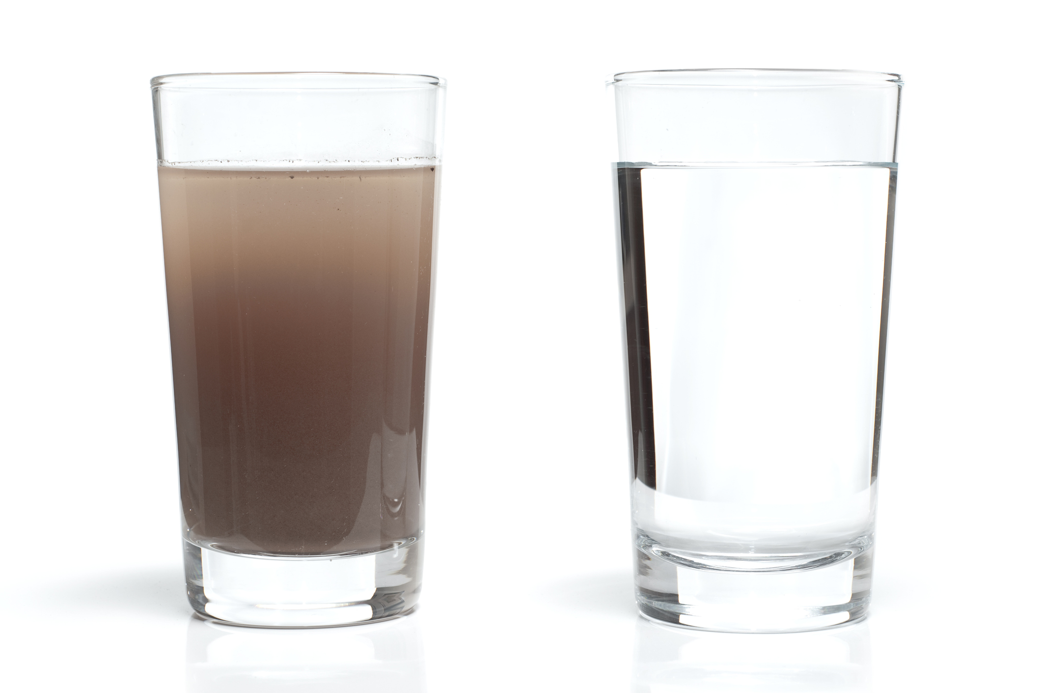 Two water glasses. One with dirty water and the other with fresh, clean water.