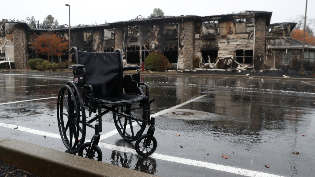 A wheelchair sits in front of a senior living facility that was destroyed by the Camp Fire in Paradise, California.