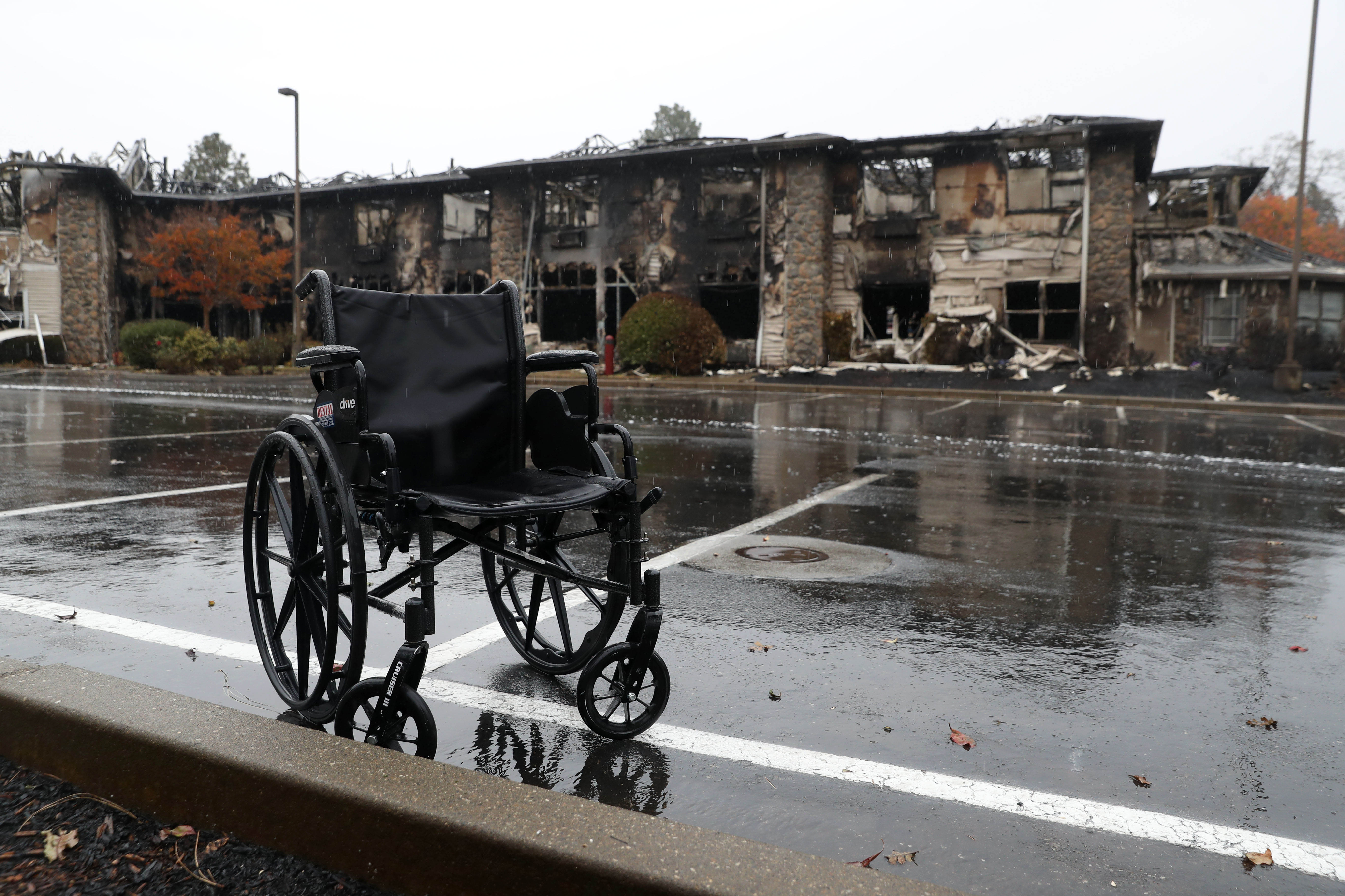 A wheelchair sits in front of a senior living facility that was destroyed by the Camp Fire in Paradise, California.