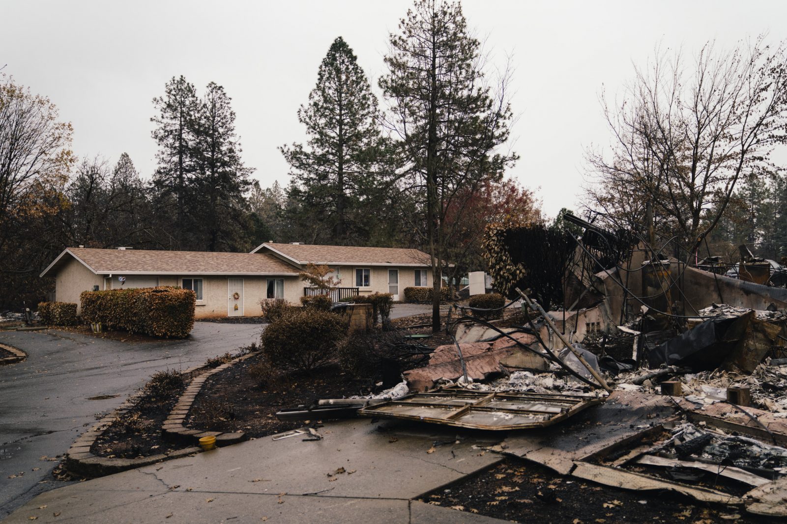 A residential apartment complex is seen standing among the debris of the Camp Fire in Paradise, California.