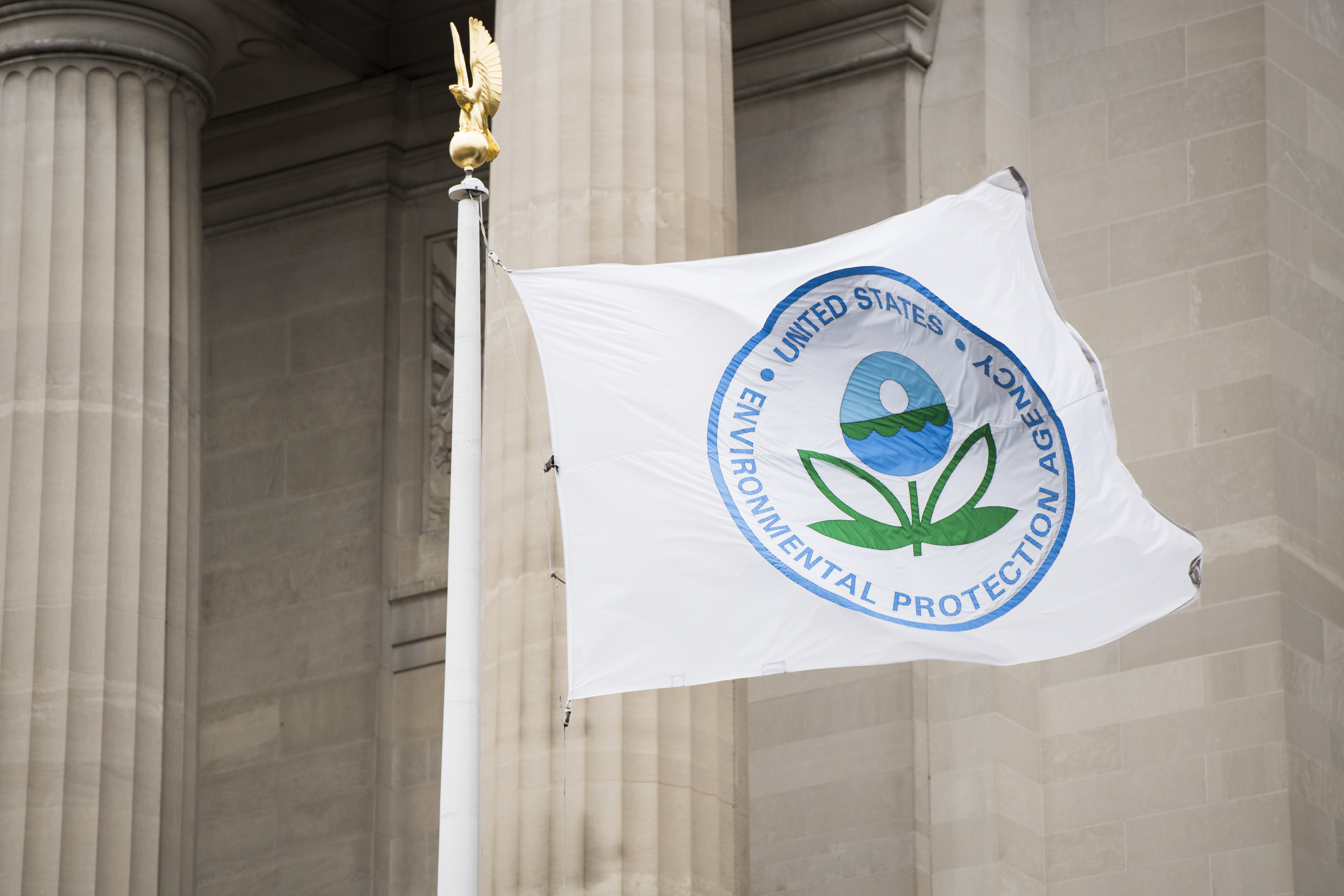 A flag with the EPA logo flies in front of the Environmental Protection Agency.