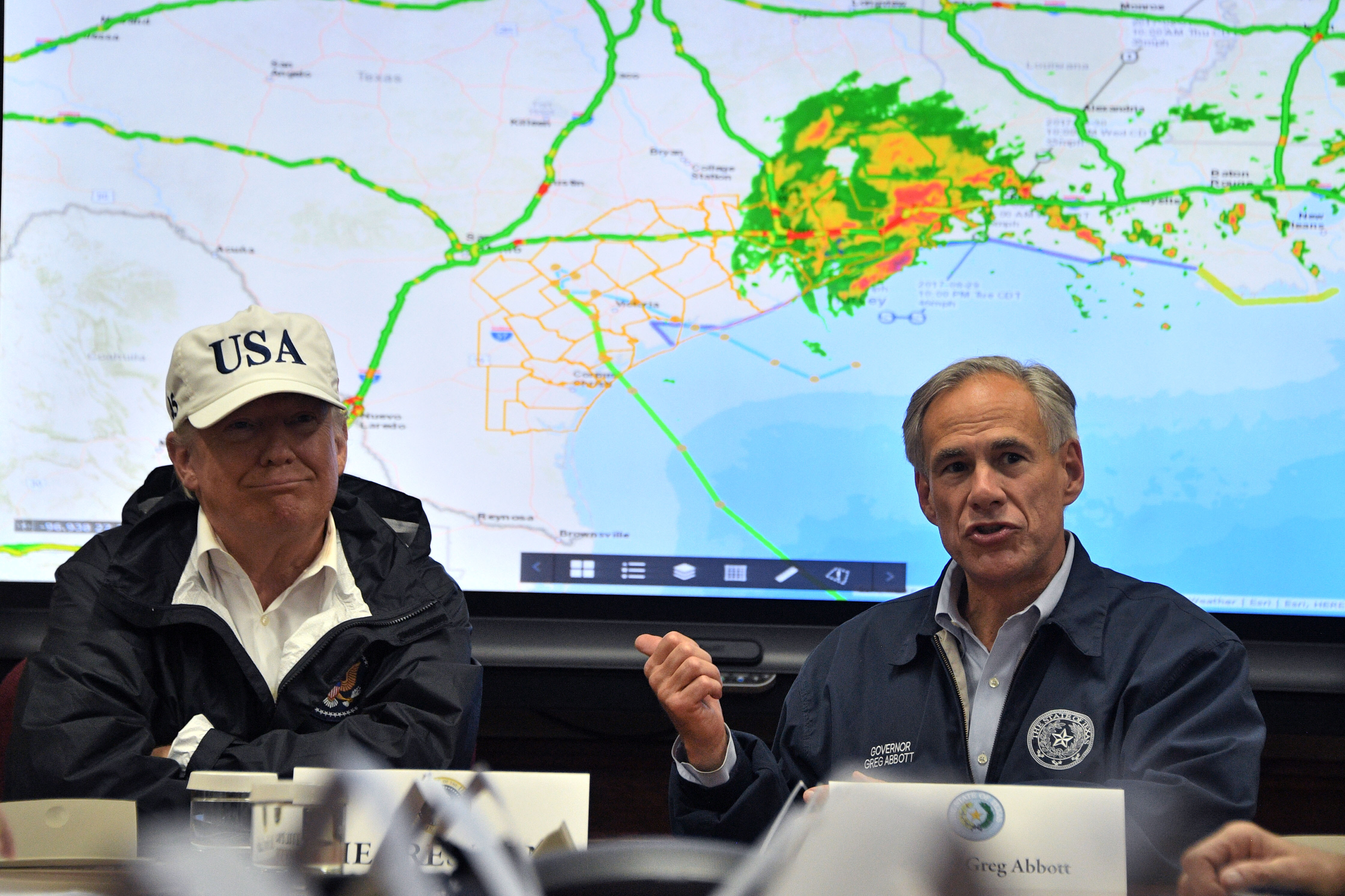 Texas Governor Greg Abbott speaks next to President Donald Trump in 2017, as rains from Hurricane Harvey continue to flood parts of Texas.