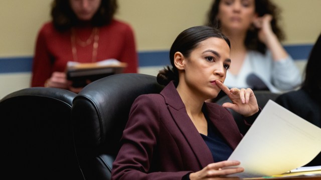 Rep. Alexandria Ocasio-Cortez (D-NY), listens as Michael Cohen, former lawyer for U.S. President Donald Trump, testifies before the House Oversight Committee on Capitol Hill, on Wednesday, February 27, 2019.