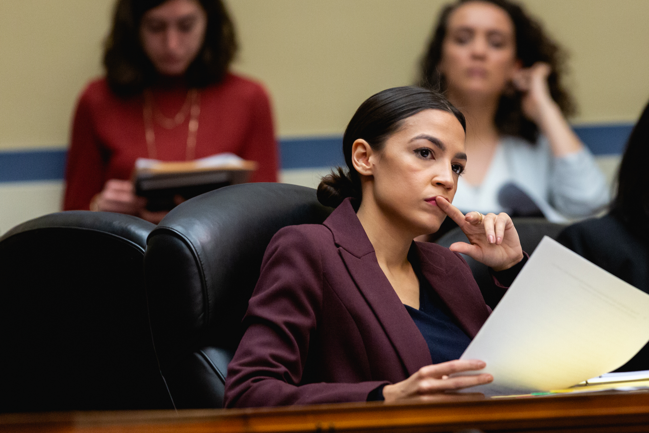 Rep. Alexandria Ocasio-Cortez (D-NY), listens as Michael Cohen, former lawyer for U.S. President Donald Trump, testifies before the House Oversight Committee on Capitol Hill, on Wednesday, February 27, 2019.