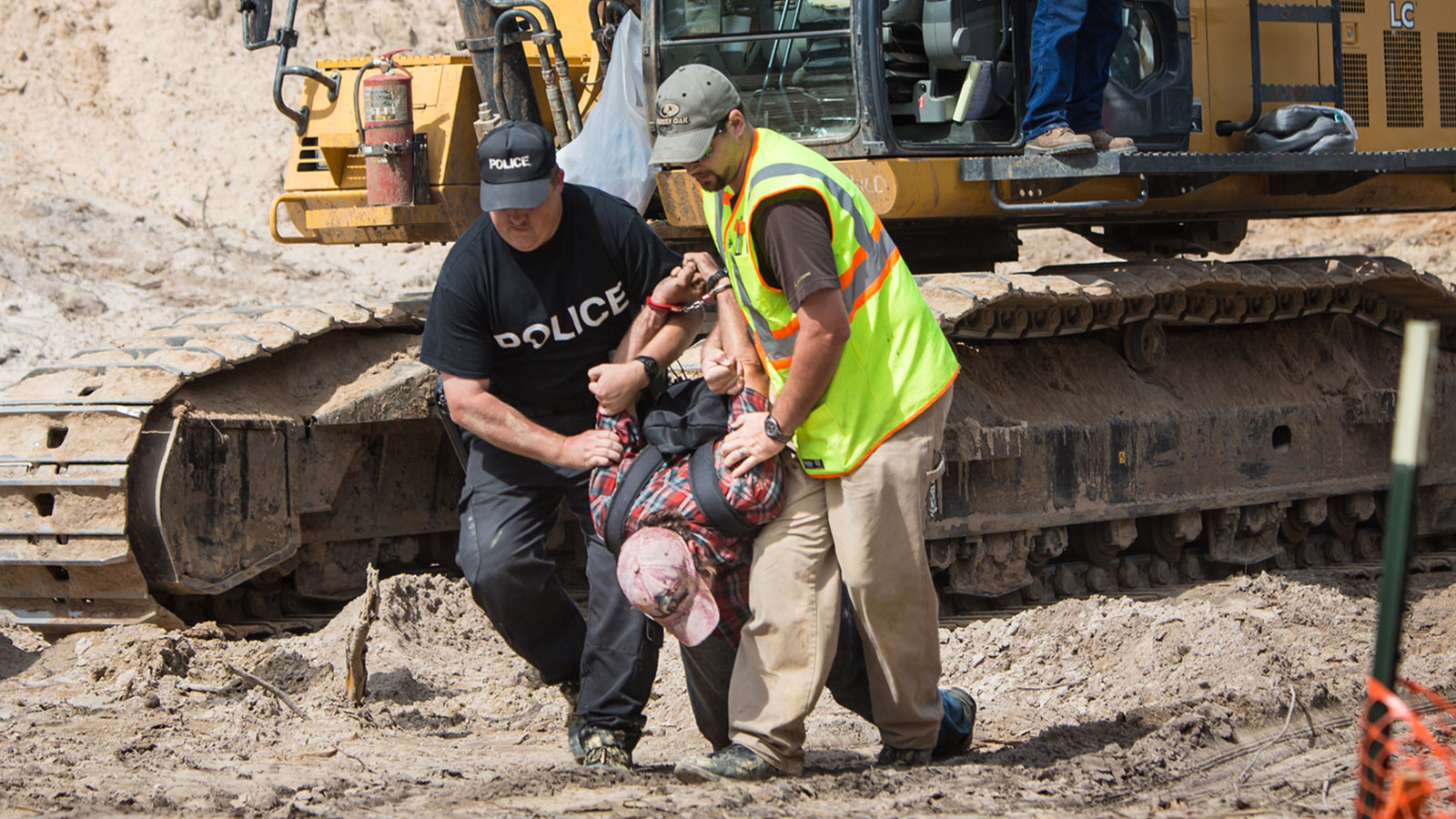 Environmental activist in the Tar Sands Blockade arrested after climbing on top of a work vehicle and attempting to attach a protest banner to it.