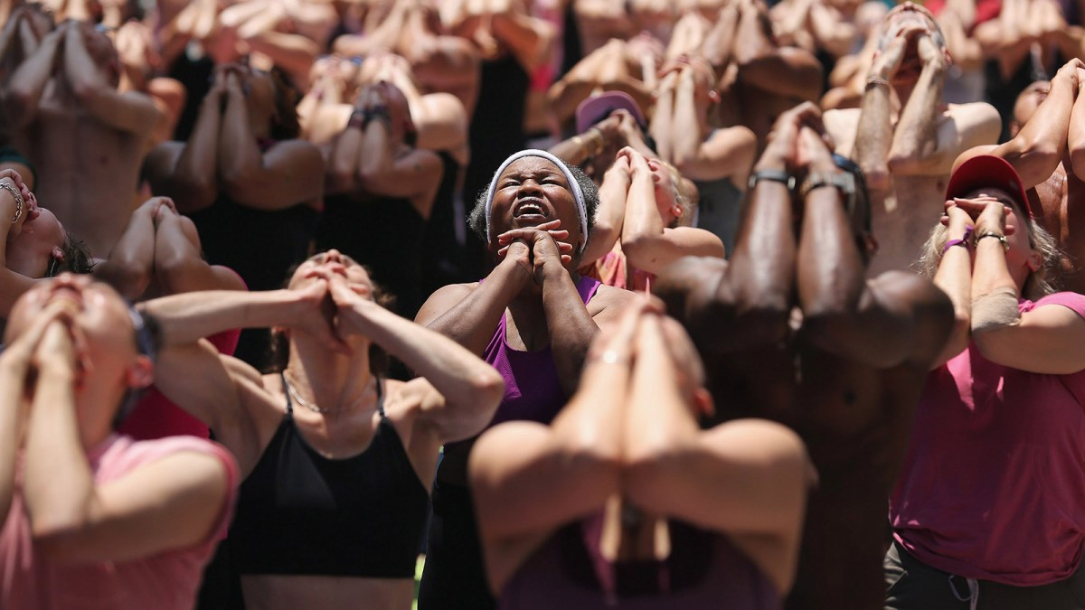 People brave high temperatures while practicing bikram yoga as part of the annual Mind Over Madness event in Times Square on June 20, 2012 in New York City.