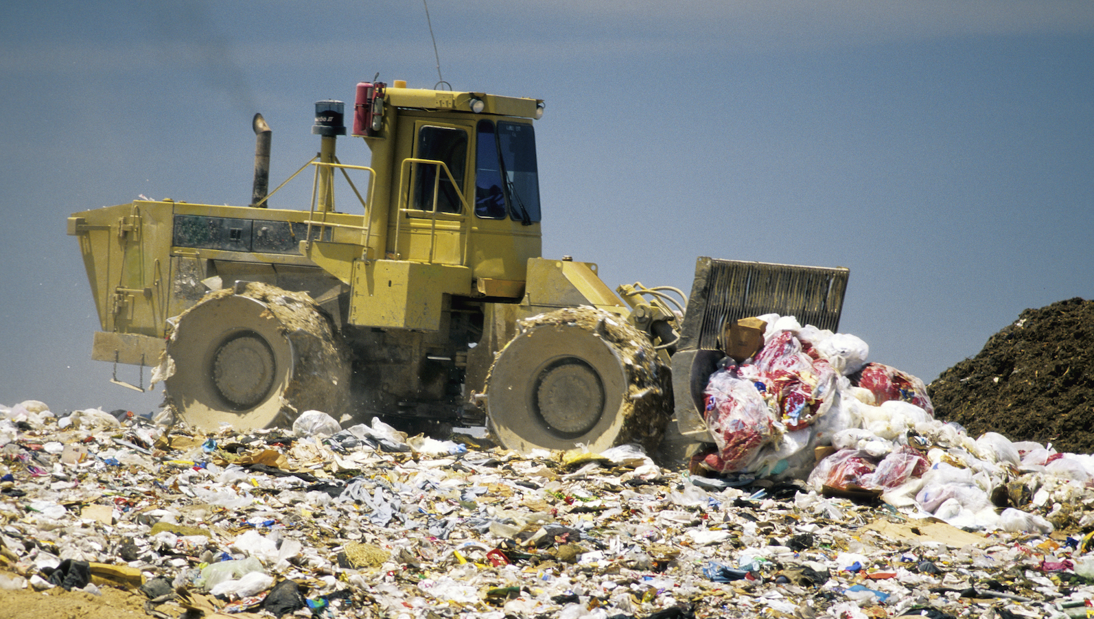 Compactor dumping trash in CA